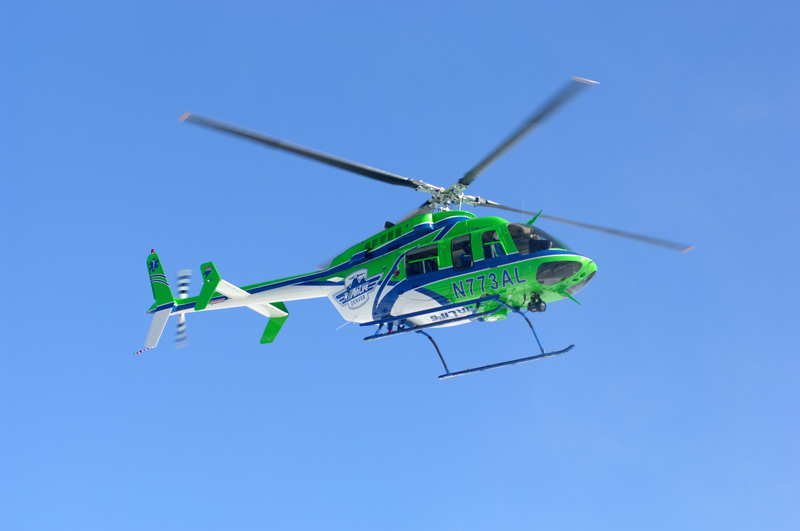 Heli flying under blue sky