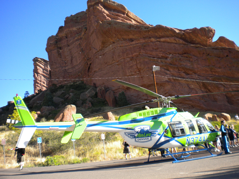 People streaming around a heli